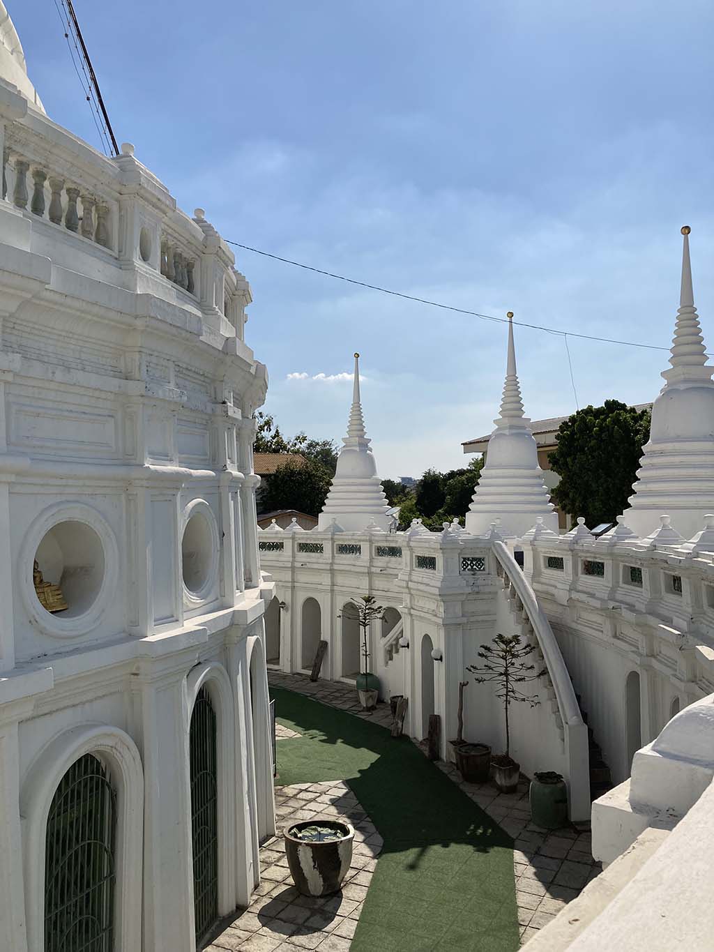 At the base of the Chedi. The stairs in this photo are leading to the walkway of the smaller chedis. While the left walkway is the entrance to the main chedi.