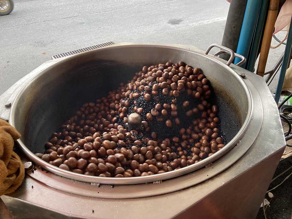 Chestnut is being roasted on the hot rock. This process will intensify the smell of chestnut.