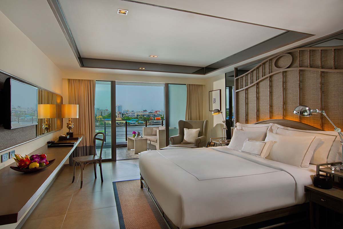 Deluxe room with river view at Riva Surya Bangkok.