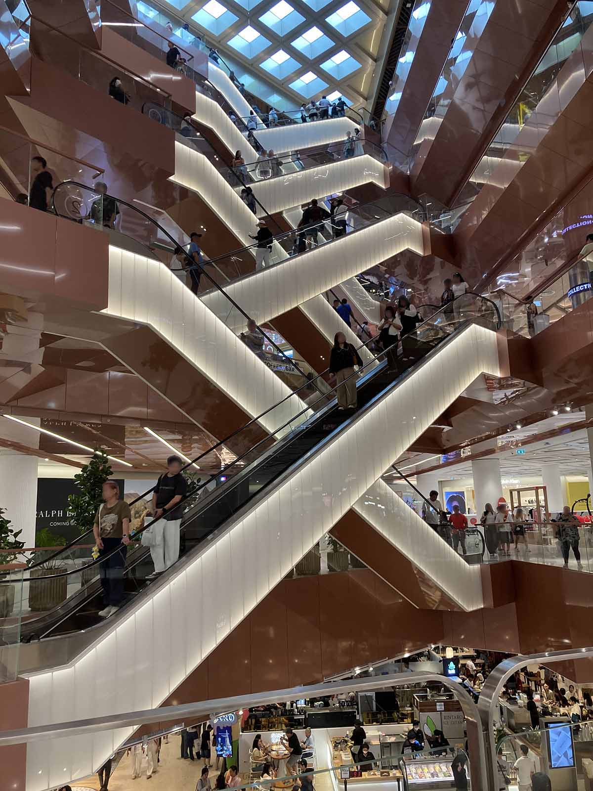 An iconic futuristic escalator hall located on the 1st floor, right behind the beauty galleys.