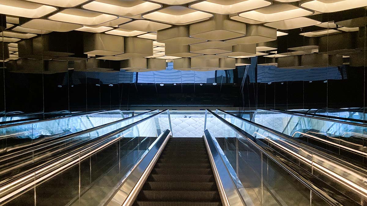 Dramatic escalator hall of One Bangkok from the entrance near subway leading you up to the central garden.