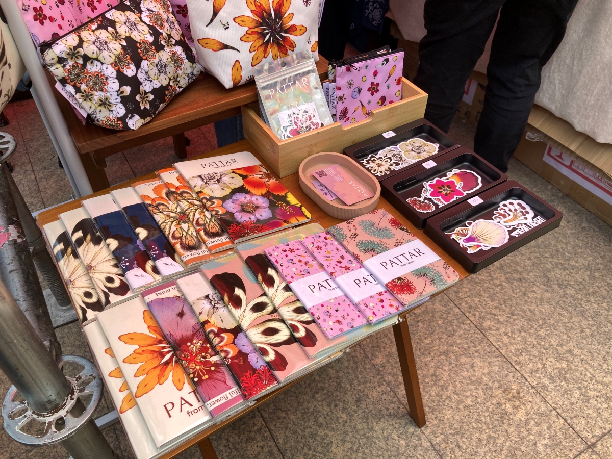 Showcasing a handcraft note book as well as many hand made costume jewelry.