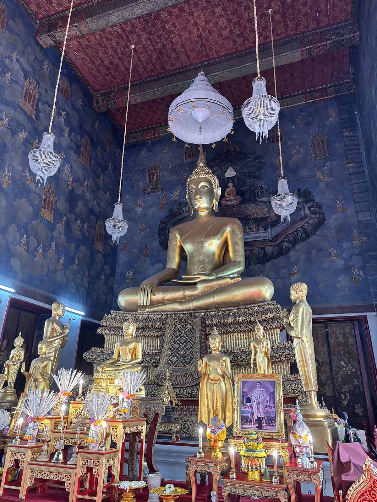 The principal Buddha statue with magnificent mural painting.